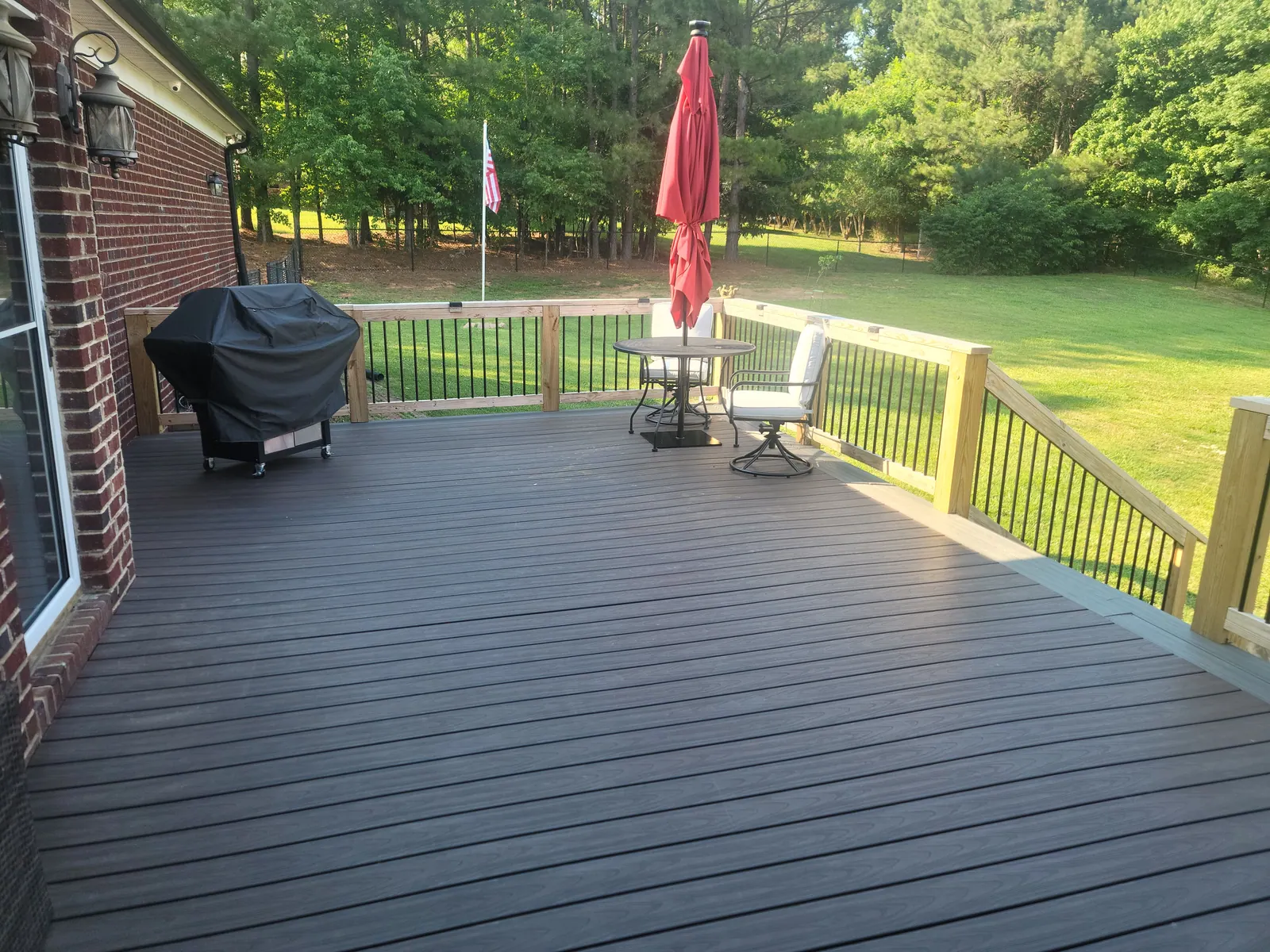 Composite deck with new railing posts being installed