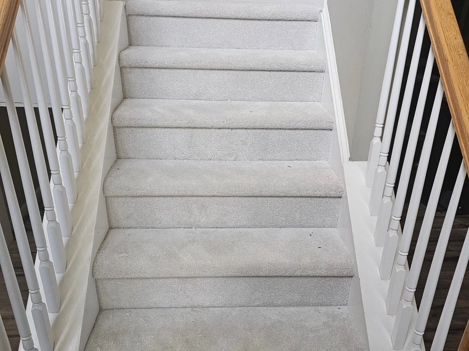 New carpet on a staircase with white balusters